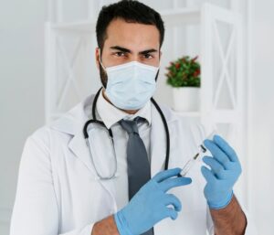 front-view-doctor-with-medical-mask-holding-syringe